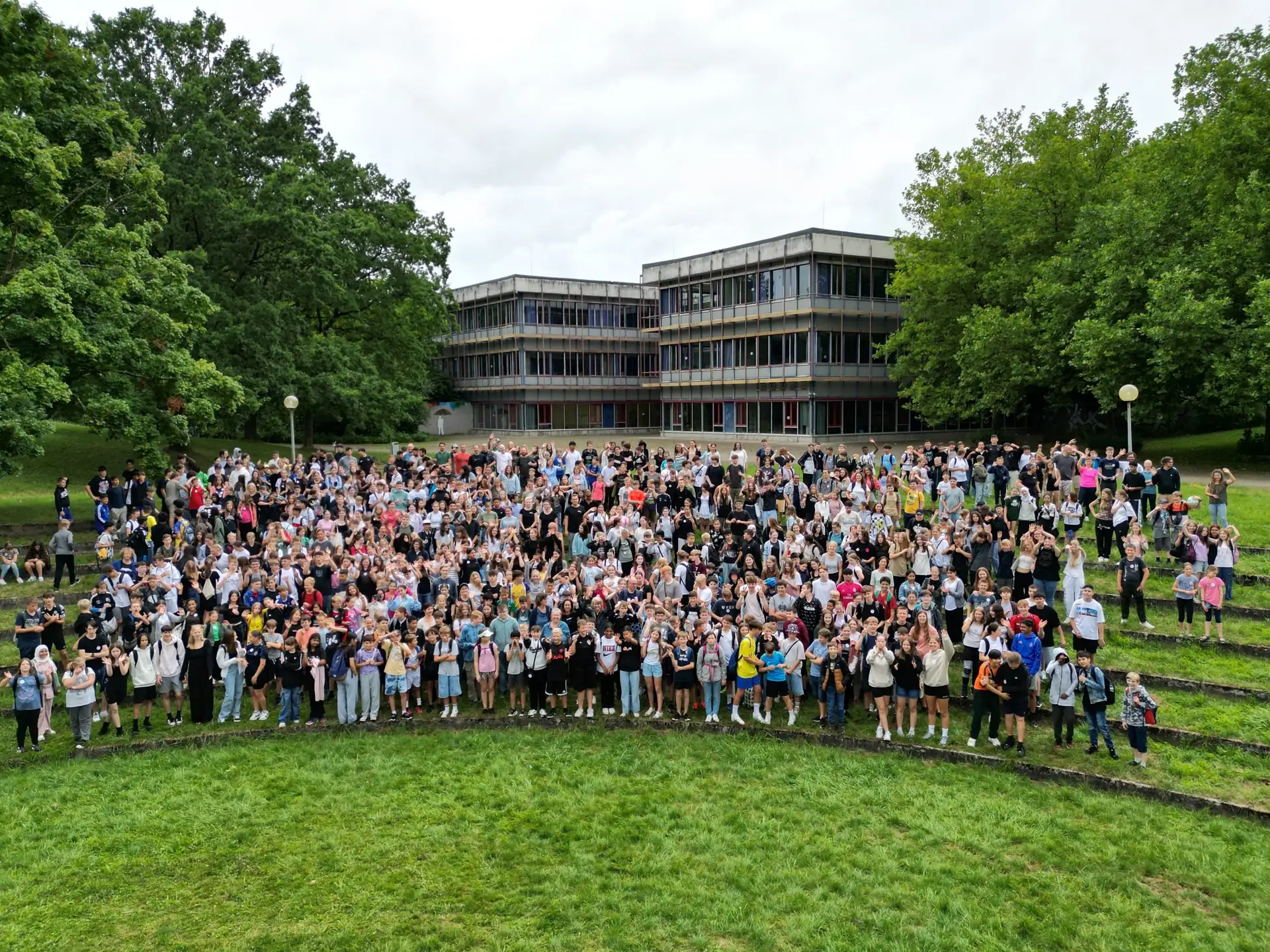 Die ganze Schulgemeinschaft vor dem Schulgebäude, von oben fotografiert